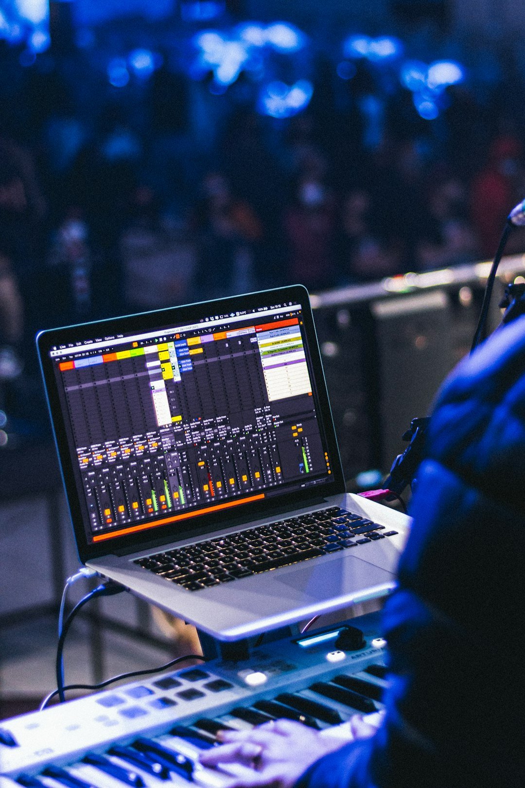 keyboardist using a computer playing a live concert